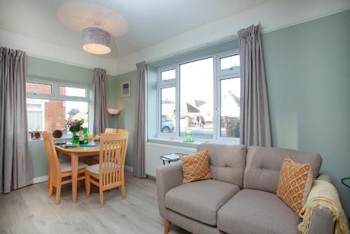 a living room with a couch and a table at Seymour House in Exmouth