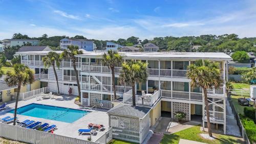 an aerial view of a house with a swimming pool and palm trees at Ocean Blvd Paradise Steps to Beach w Pool and Grill in Myrtle Beach