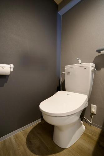 a bathroom with a white toilet in a room at Hotel KOTO in Sapporo