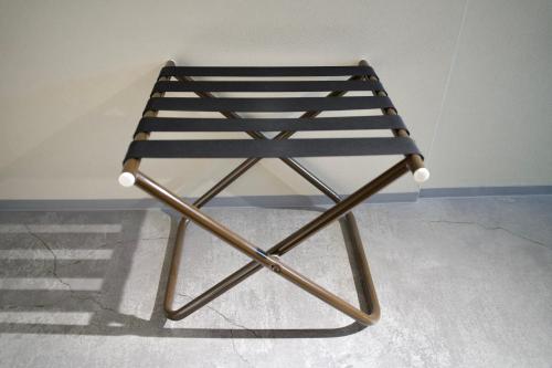 a chair sitting in front of a wall at Hotel KOTO in Sapporo