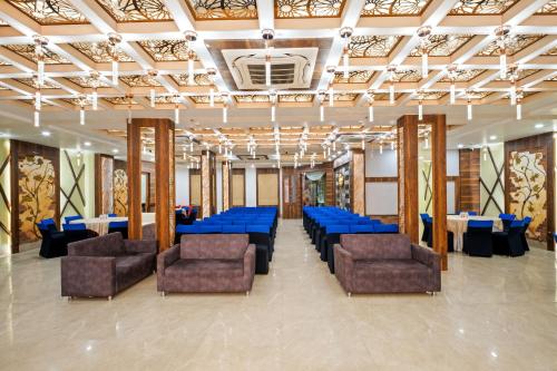 a banquet hall with blue tables and chairs at PRIME LAND in Varanasi