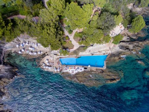 an aerial view of a resort near the water at Hôtel Le Provençal - Rénové en 2025 - Bord de Mer in Hyères