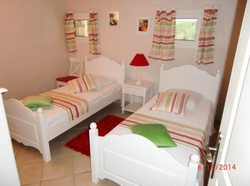 - une chambre avec 2 lits et un tapis rouge dans l'établissement Mare a Mare, à Porto-Vecchio