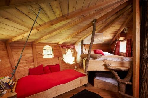 a room with two beds in a wooden house at Cabanes de la Grande Noe in Les Épasses