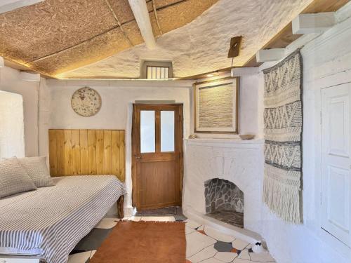 a room with a fireplace and a bed in it at Aikkya Farms in Mukteswar