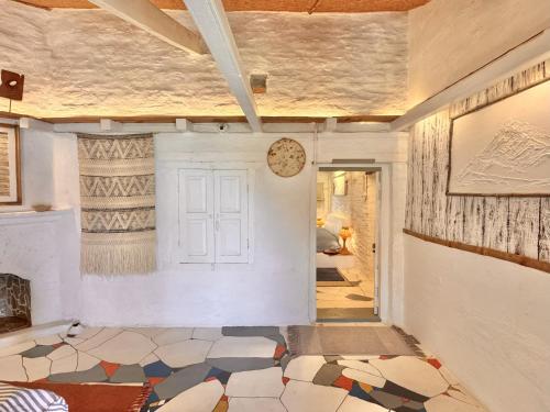 a hallway with a room with a door and a tile floor at Aikkya Farms in Mukteswar