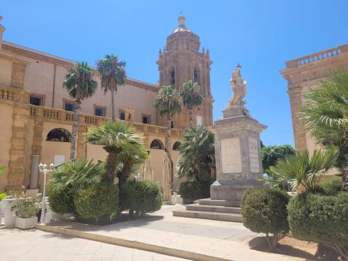 a large building with a statue in front of it at Casa Isabel in Mazara del Vallo