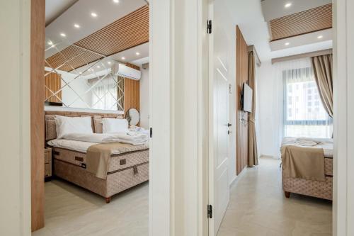 a bedroom with two beds and a hallway at Vienna Luxury Apartments in Dobra Voda