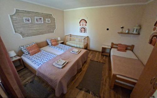 a small bedroom with a bed and a crib at Villa Sunset in Palić