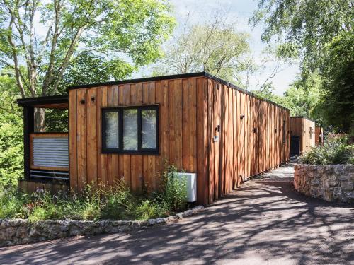 a wooden tiny house with a fence at Gwynant Lodge - Uk47608 in Caernarfon