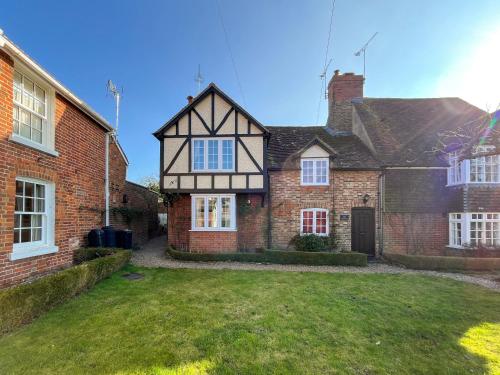 an old brick house with a grass yard at Green Trees in Maidstone