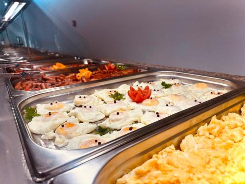 a buffet line with many different types of food at Hotel Agora in Neptun