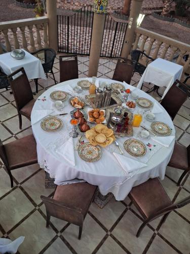 a table with plates of food on top of it at Eden Suites 