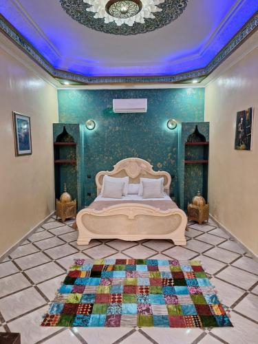 a bedroom with a bed and a blue wall at Eden Suites 