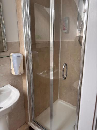 a shower with a glass door in a bathroom at The Park Lodge in Kinsale