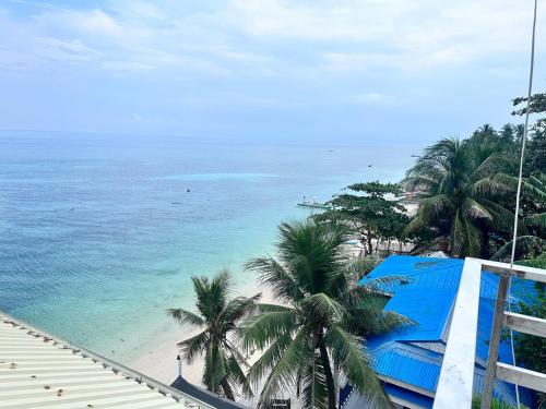 a view of a beach with palm trees and the ocean at Becca's Vacation House 