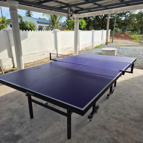 a ping pong table sitting under a pavilion at Lumayan Guesthouse, Pantai Murni in Yan