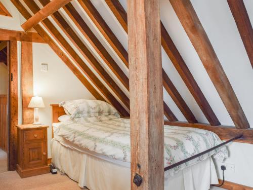 a bedroom with a bed in a attic at The Old Stable - Meadowbrook Farm in Thame