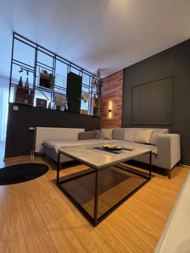 a living room with a couch and a table at Apartment 2 Plisi Gjilan in Gjilan
