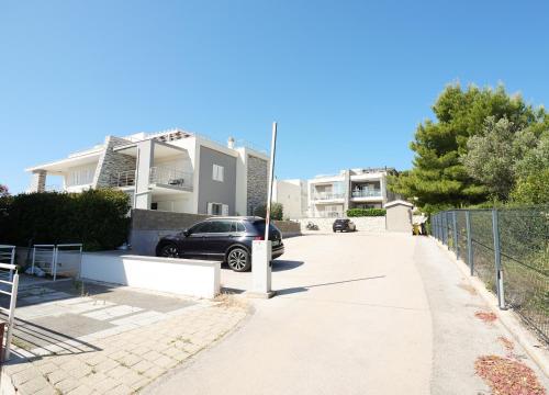 a car parked in the driveway of a house at Murter - New apartment near Podvrske beach in Murter