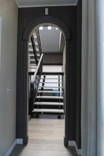 an archway leading up to a staircase in a house at Banama Coliving & Coworking, Surf & Yoga - Casa Roja in Corralejo