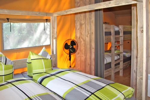 a bedroom with a bed and two bunk beds at Safarizelte in Lychen