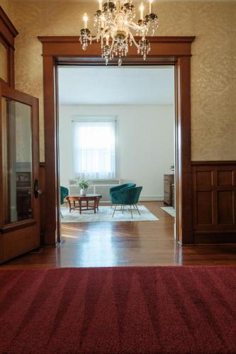 an open door to a living room with a chandelier at Oakridge House. Spacious and historic home in downtown Ironton, Ohio. in Ironton
