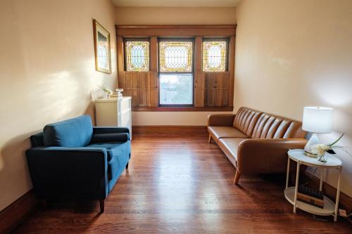 a living room with a couch and two chairs at Oakridge House. Spacious and historic home in downtown Ironton, Ohio. in Ironton