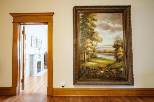 a large painting on a wall in a room at Oakridge House. Spacious and historic home in downtown Ironton, Ohio. in Ironton