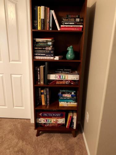 a book shelf filled with books next to a door at Amazing Gilbert home 3 Bed 2 and half Bath sleeps 8 2 car garage in Gilbert