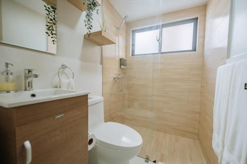 a bathroom with a toilet and a sink and a shower at 2 BR cozy apartment 3 minutes to Downtown Punta Cana in Punta Cana