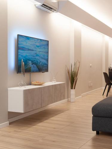a living room with a flat screen tv on a wall at Rimini Centro Loft Open Space Titan's Lair in Rimini
