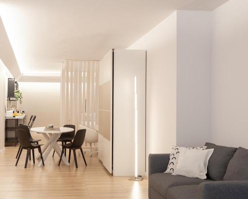 a living room with a couch and a table at Rimini Centro Loft Open Space Titan's Lair in Rimini