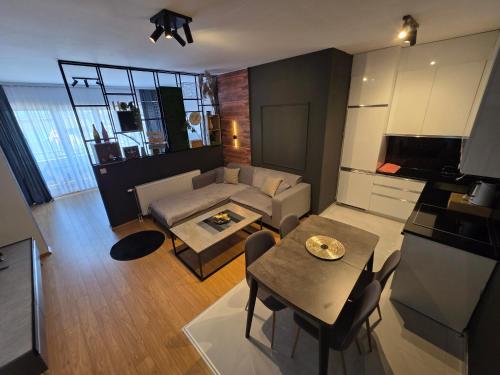 a living room with a couch and a table at Apartment 2 Plisi Gjilan in Gjilan