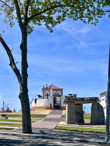 a building with a tree in front of it at Monte da Aferrada - CASAS DA VILA in Alpalhão