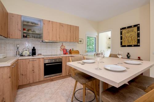 a kitchen with a table with wine glasses on it at Villa Romy in Alexandroupoli