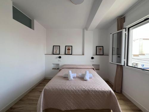 una camera da letto con un letto con due asciugamani sopra di Apartamento Marina Centro a Ronda
