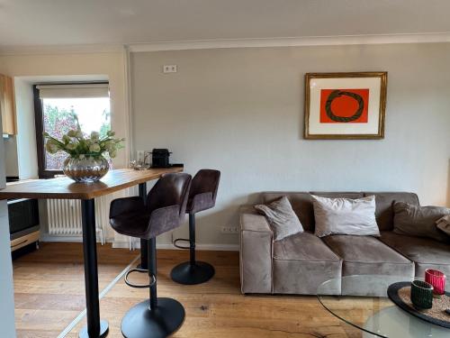 a living room with a couch and a table at Lakefront Studio - Teil der HolidayEscapes Kollektion in Scharbeutz