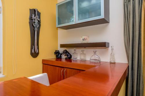 a dining room with a wooden table and a cabinet at Villa Romy in Alexandroupoli