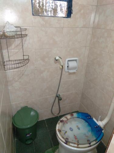 a bathroom with a toilet with a fish bowl seat at Quarto duplo de frente para o mar, Casa da Jô in Angra dos Reis