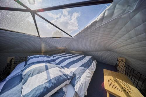 a bed in a room with a window at Glamping Slapy in Slapy