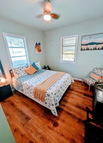 a bedroom with a bed and a ceiling fan at 2 BR Quaint Private Bungalow NR Downtown & Beaches in Pensacola