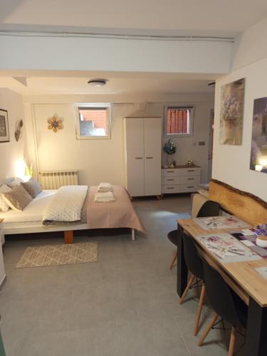 a bedroom with a bed and a table in it at Mieszkanie do wynajęcia w Centrum in Olecko