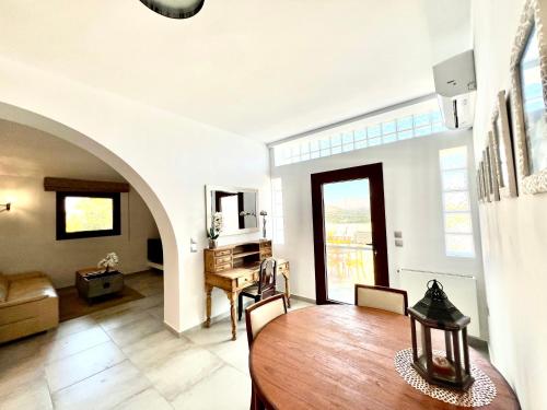 a living room with a table and a dining room at 2 bedroom self-contained apartment and swimming pool at Palm Tree Villa in Anavissos