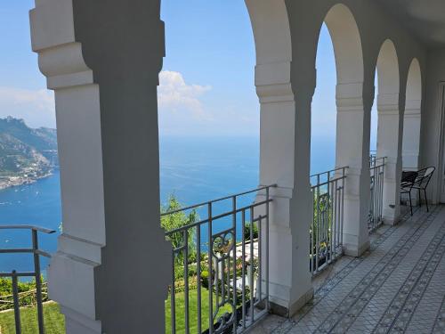 a balcony of a building with a view of the ocean at Blue Sunset in Ravello