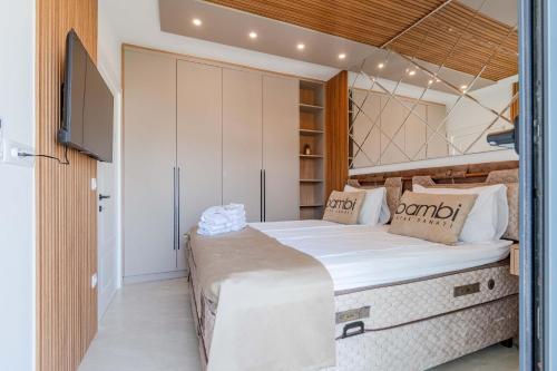 a bedroom with a large bed and a tv at Vienna Luxury Apartments in Dobra Voda
