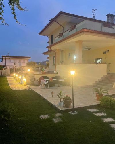 a house with a patio with lights in the yard at Fabiola home in Borgo Montenero