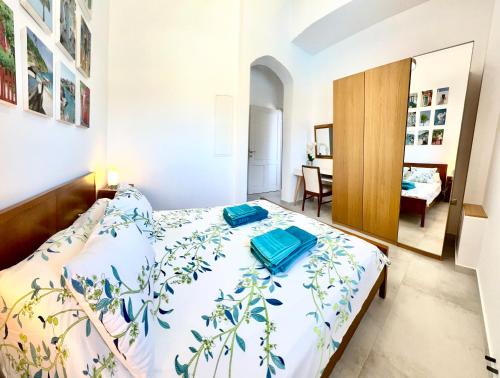 a bedroom with a bed with blue towels on it at 2 bedroom self-contained apartment and swimming pool at Palm Tree Villa in Anavissos