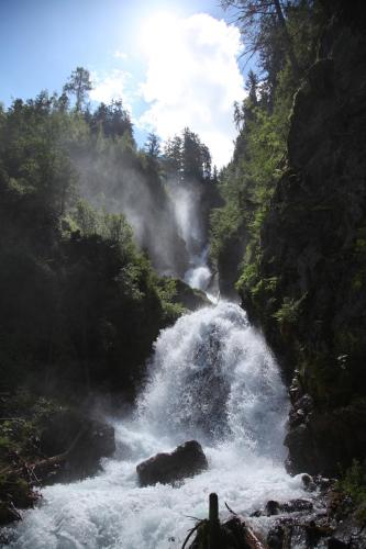 a waterfall on a river in a forest at Kleiner Alpiner Boudoir in der Residenz Silvretta - Inklusive Silvretta Card Premium in See