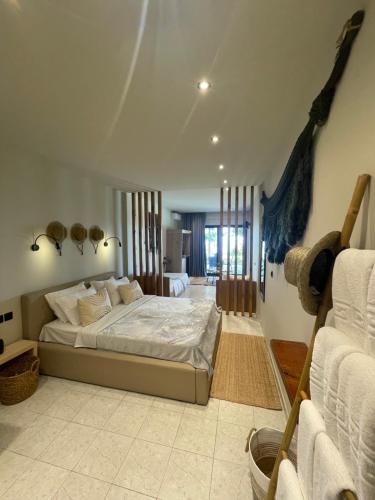 a bedroom with a large bed in a room at MOLA PAPAYA STUDIOS in Mola Kalyva